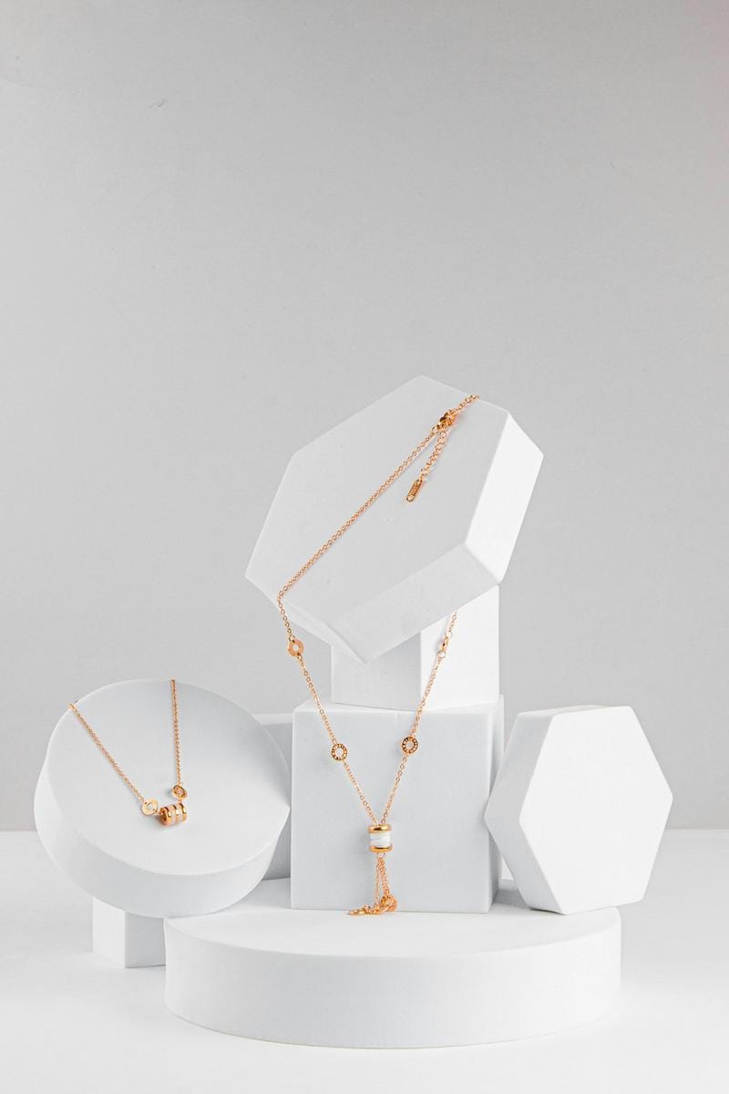 A collection of minimalist, geometric handmade jewelry, highlighting modern design and sustainable materials.