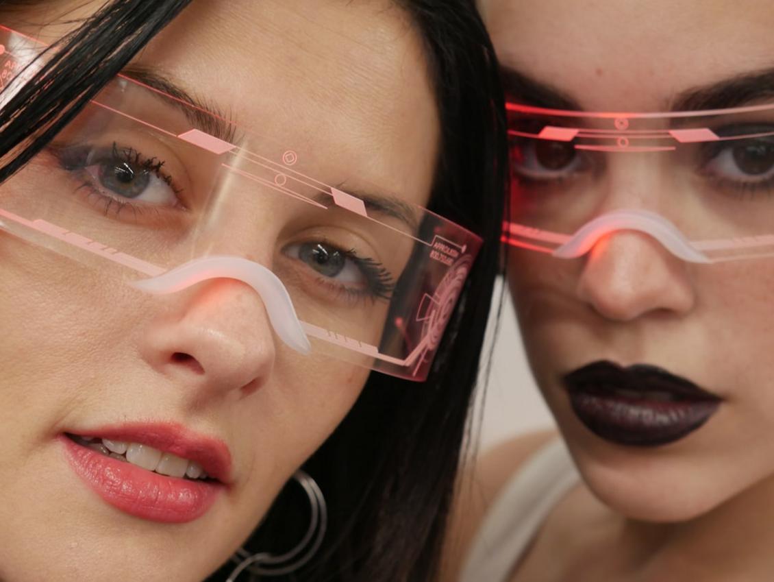 Futuristic handmade jewelry pieces with geometric designs and high-tech textures displayed on a minimalist background.