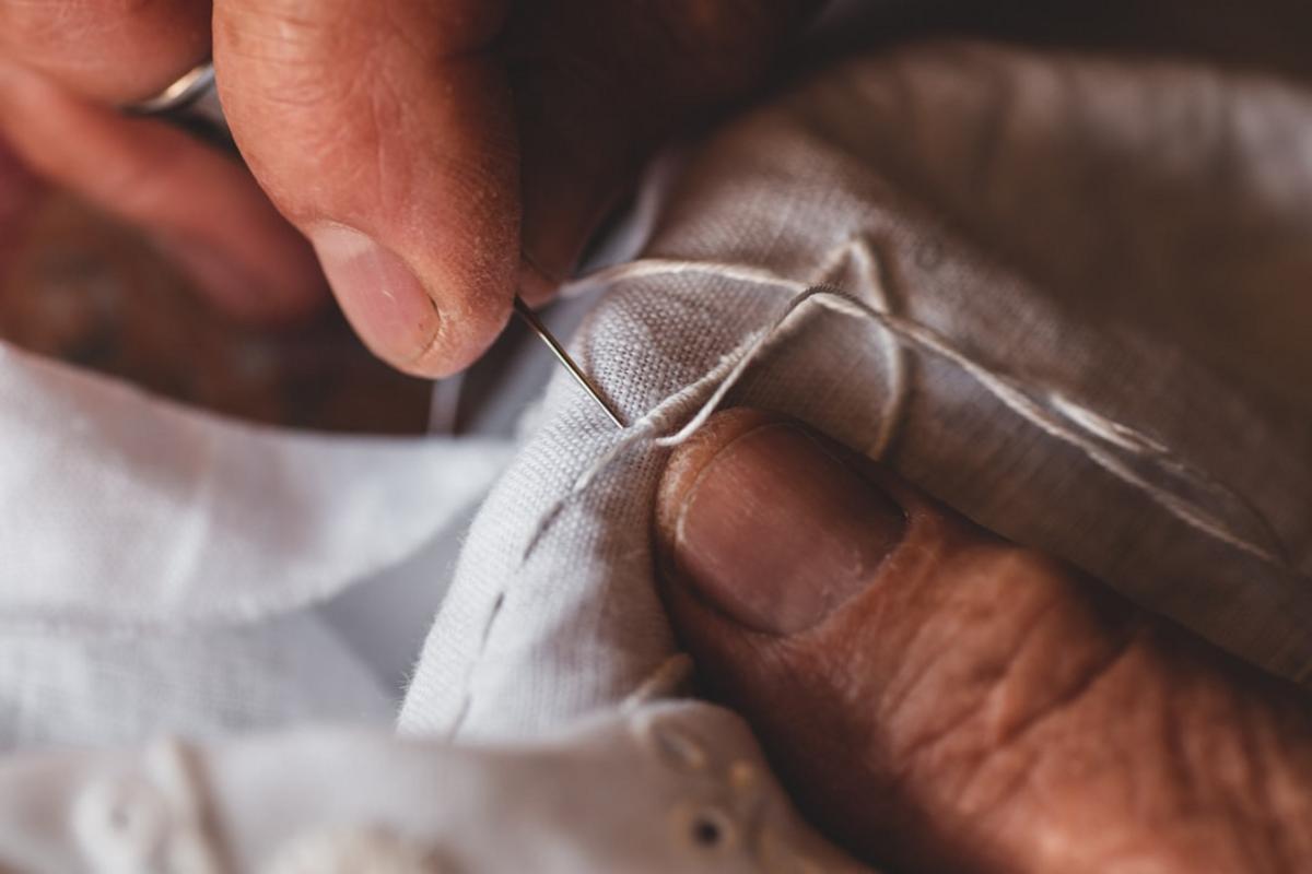 A skilled artisan hand-curving a silver bracelet, detailed craftsmanship visible