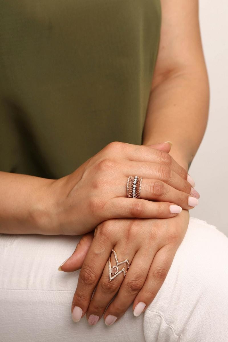 a woman wearing layered artisanal jewelry with casual and elegant outfits